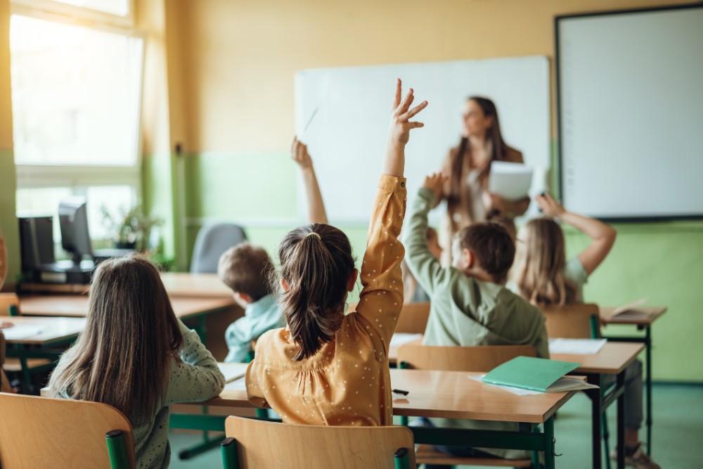 students raising hands